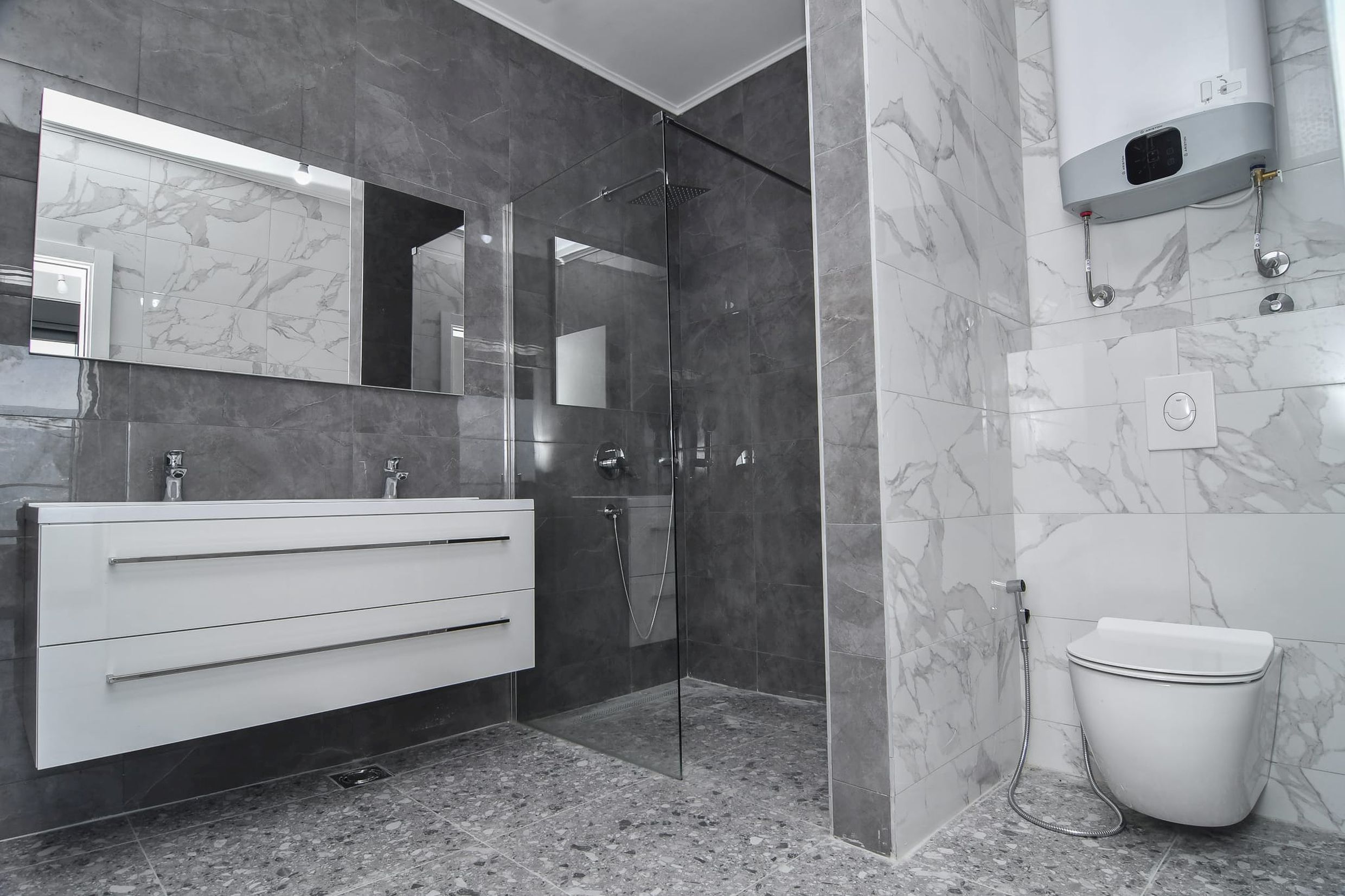 Modern bathroom with a shower cabin and marble-style finishes in a villa in Budva, Montenegro.
