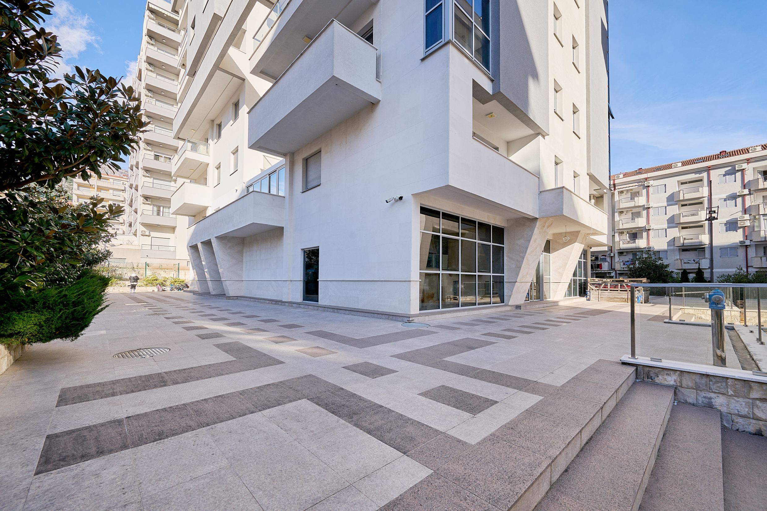 Modern residential complex with panoramic glazing and terraces in Budva, Montenegro. Building facade, exterior view.