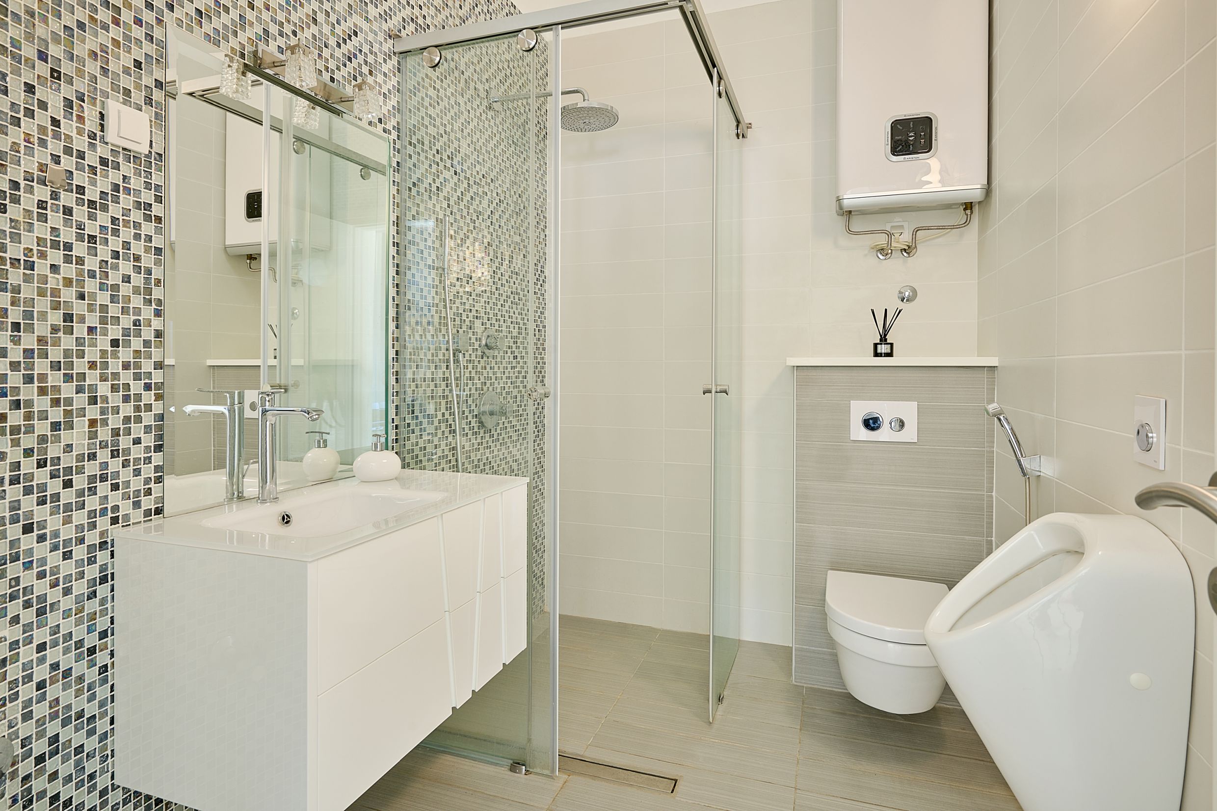 Modern bathroom with a shower cabin and mosaic in an apartment in Budva, Montenegro.