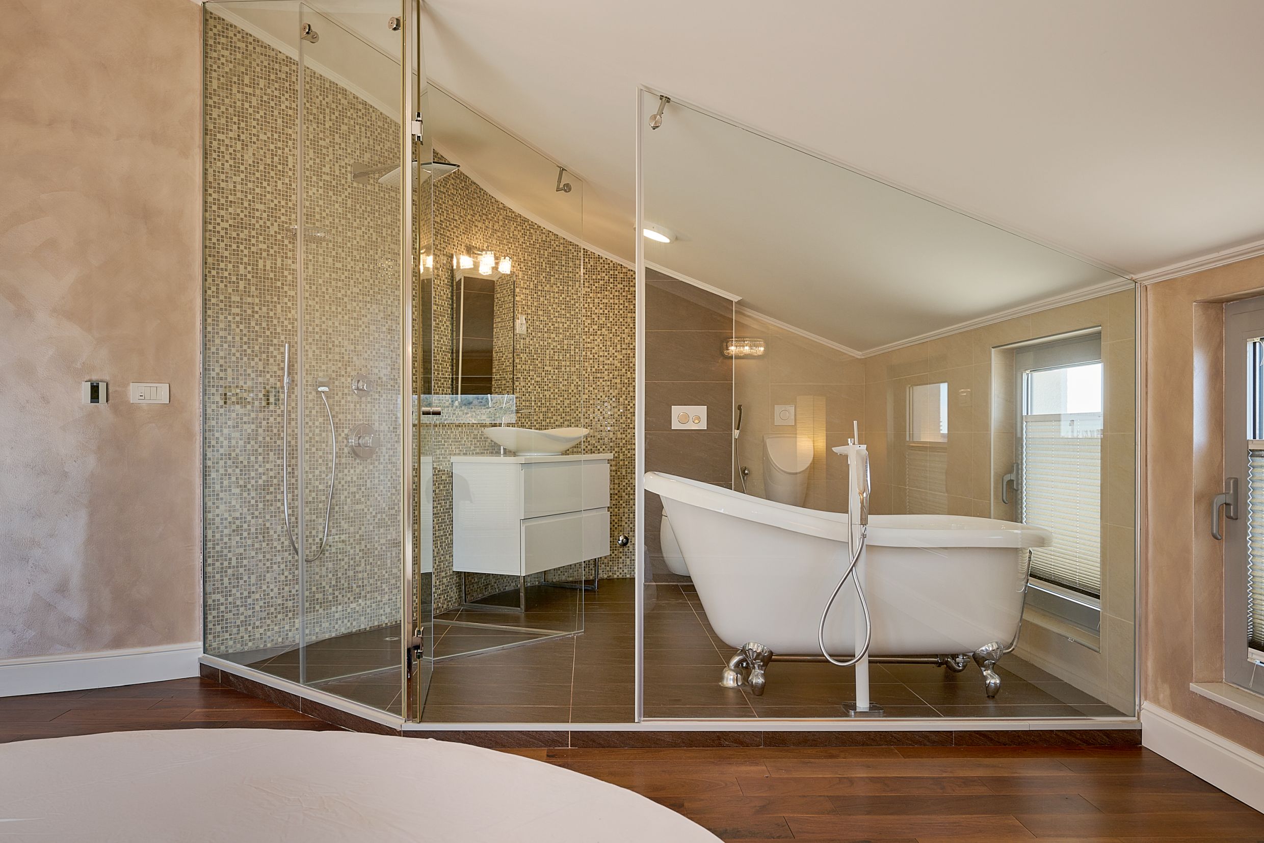 Modern bathroom with a freestanding bathtub and glass shower in an apartment in Budva, Montenegro.