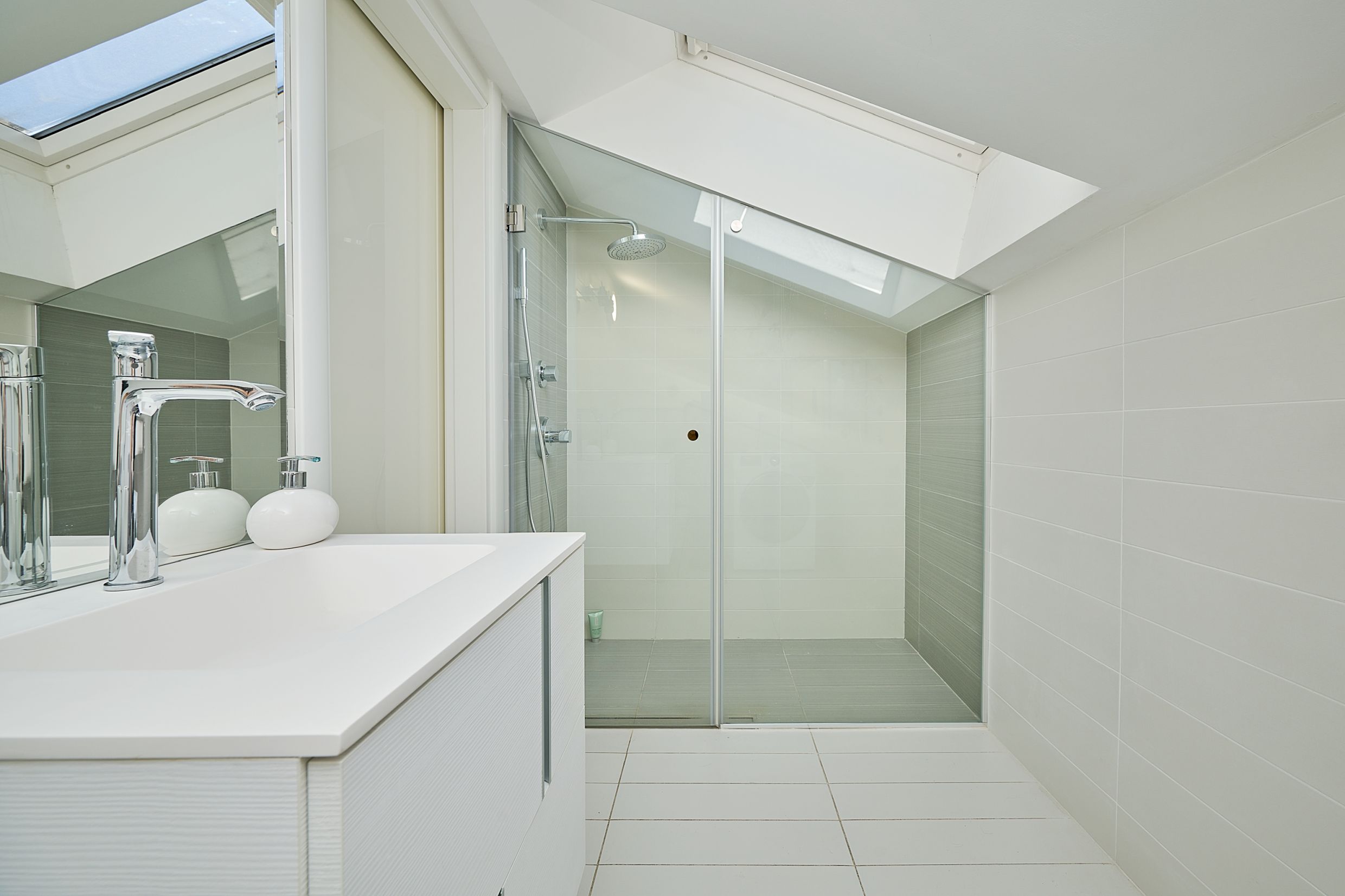 Modern bathroom with a shower cabin and a skylight in an apartment in Budva, Montenegro.