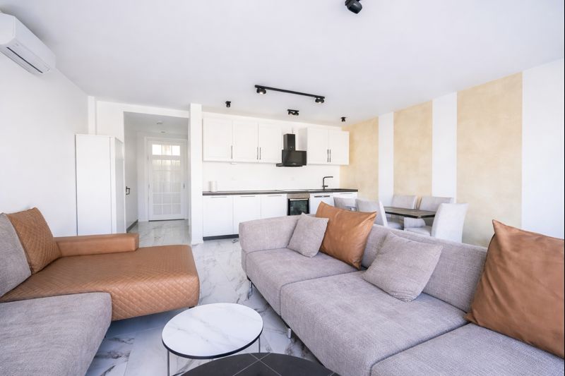 Modern living room with a soft sofa and kitchen in a townhouse, Luštica, Montenegro