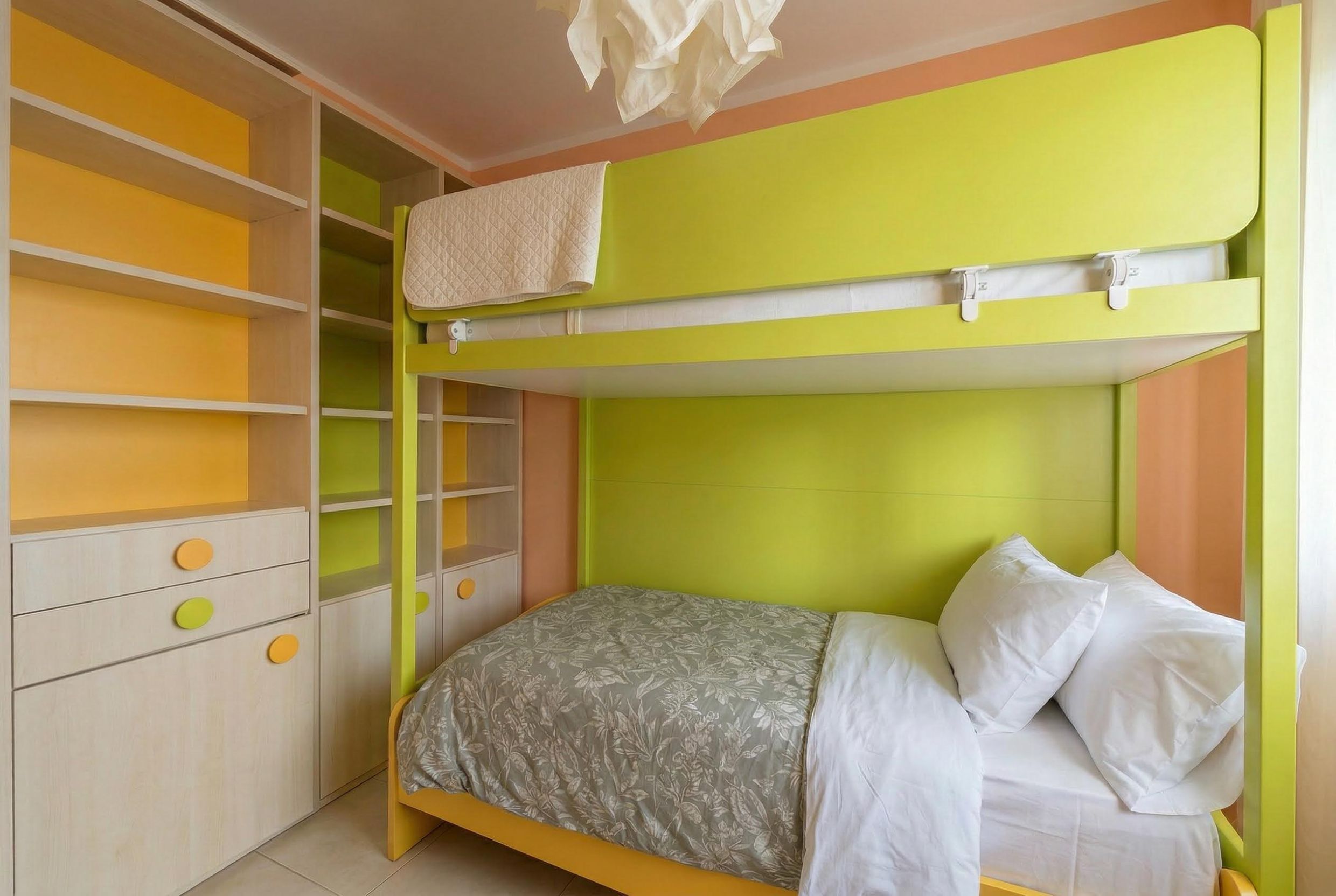 Children’s bedroom with a bunk bed and built-in shelving in an apartment in Bečići, Montenegro.