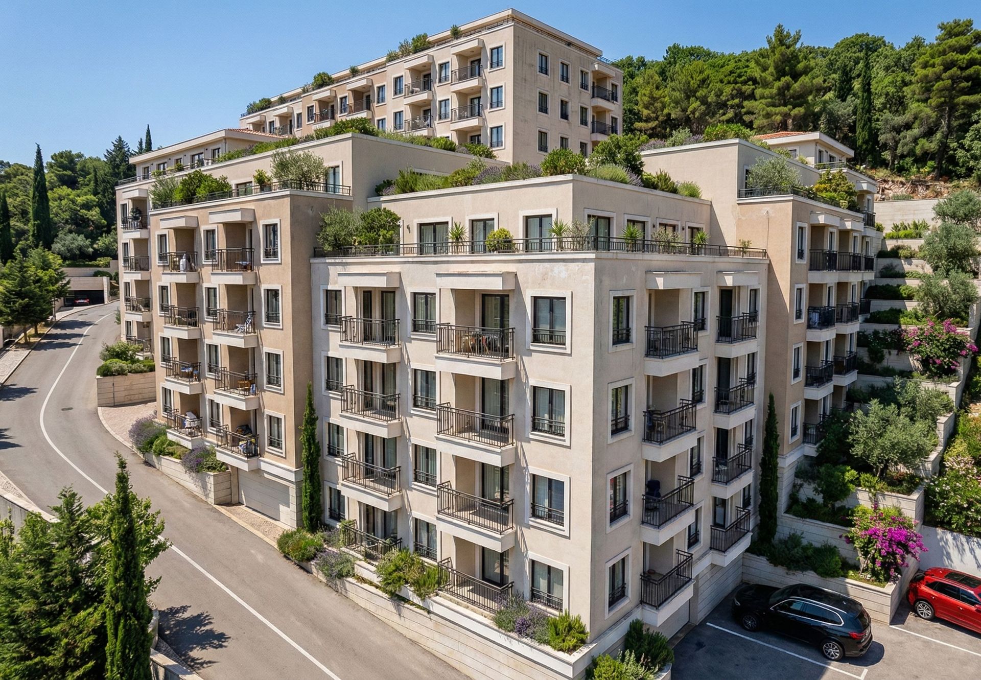 Modern residential complex in Budva, Montenegro: an apartment building with terraces, landscaping, and balconies.