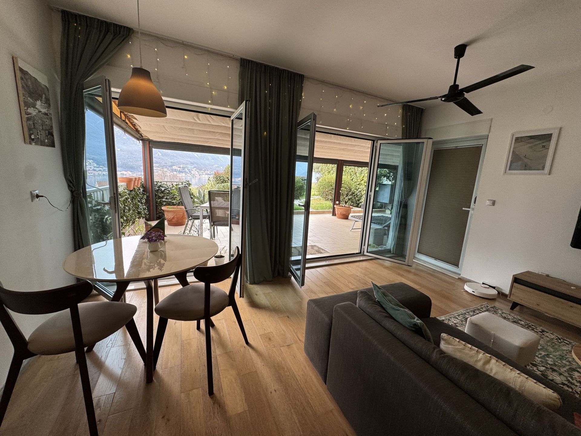 Living room with access to the terrace and sea view in an apartment, Dobrota, Montenegro: modern furniture and a bright interior.