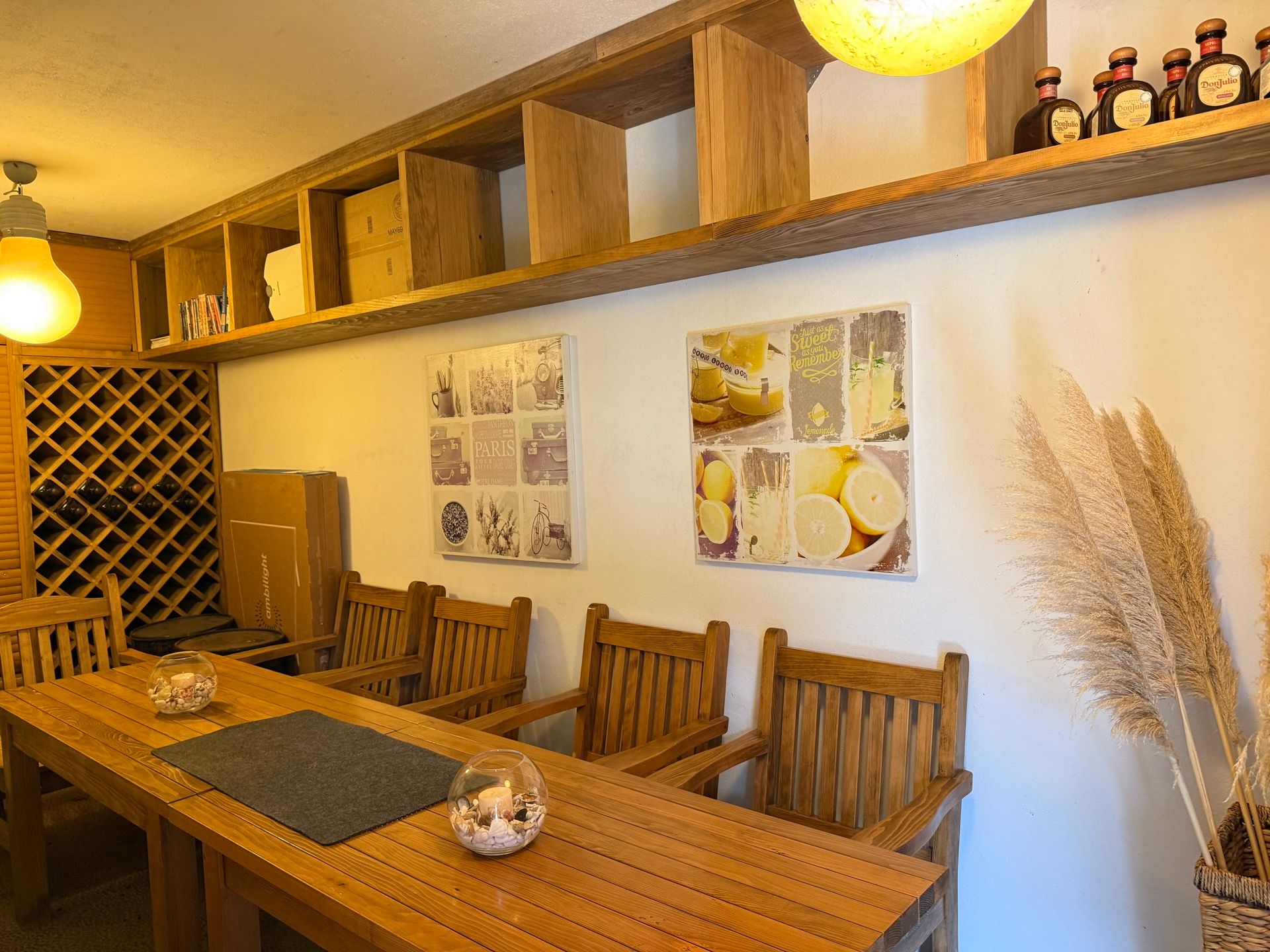 Living room interior in an apartment in Dobrota, Montenegro: a wooden dining table, chairs, and a rustic wine rack.