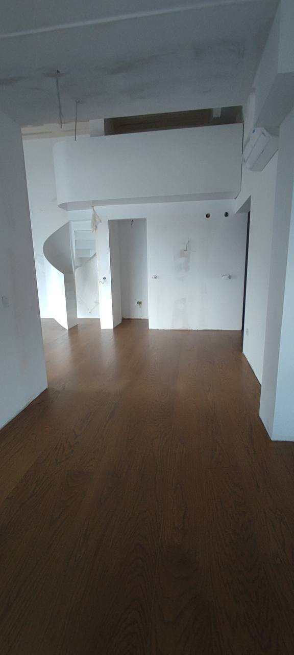 Living room in a penthouse in Budva, Montenegro: duplex apartment with high-quality finishes and parquet flooring.