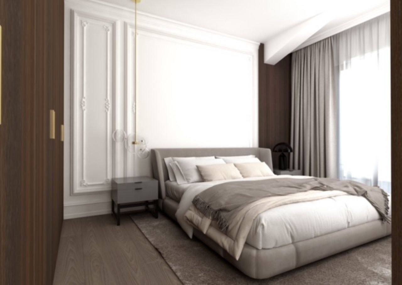 Modern bedroom in a penthouse in Budva, Montenegro: double bed, wall moldings, and panoramic window.
