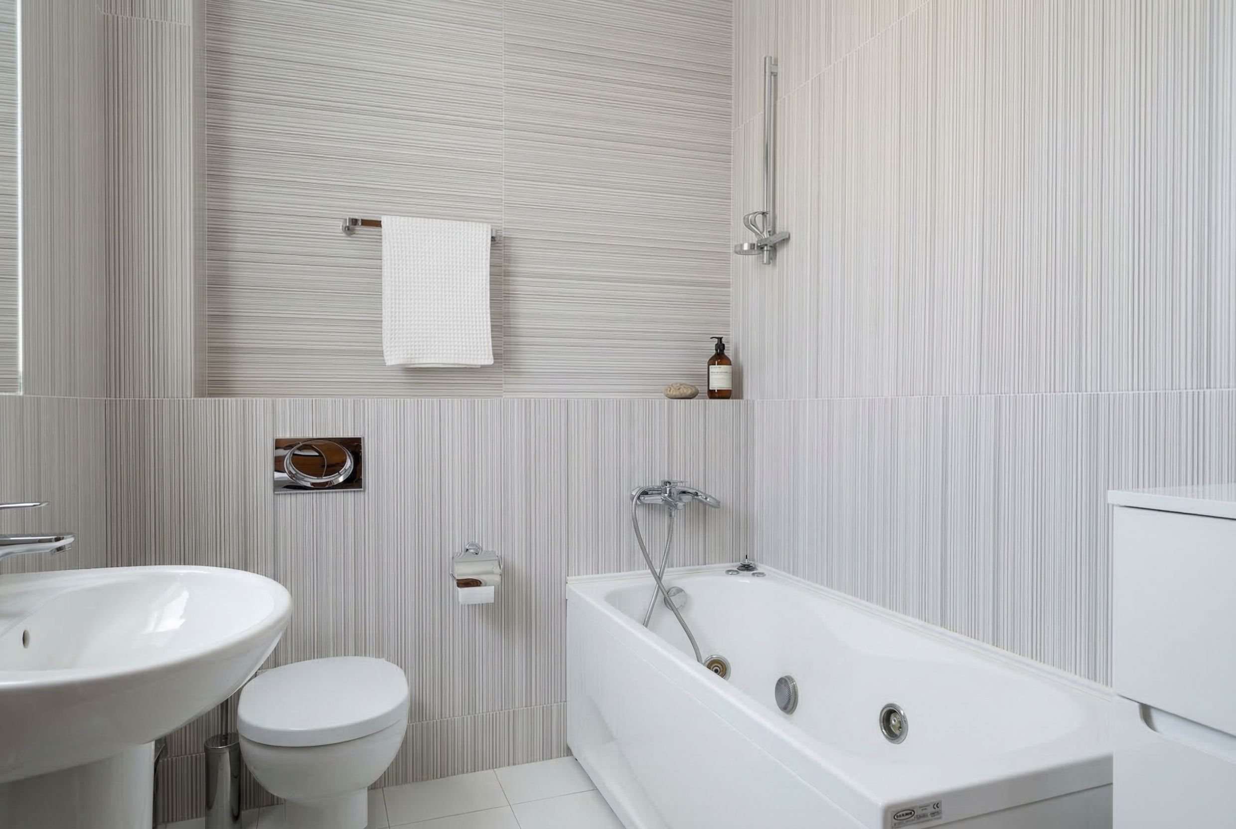 Modern bathroom with a jacuzzi in a penthouse, Kamenovo, Montenegro: light tiles and high-quality fixtures.