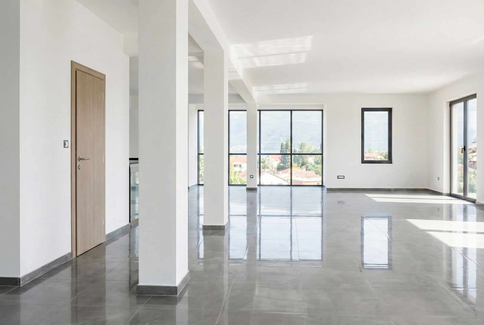 Bright living room with panoramic windows and glossy flooring in a new property, Baošići, Herceg Novi, Montenegro.