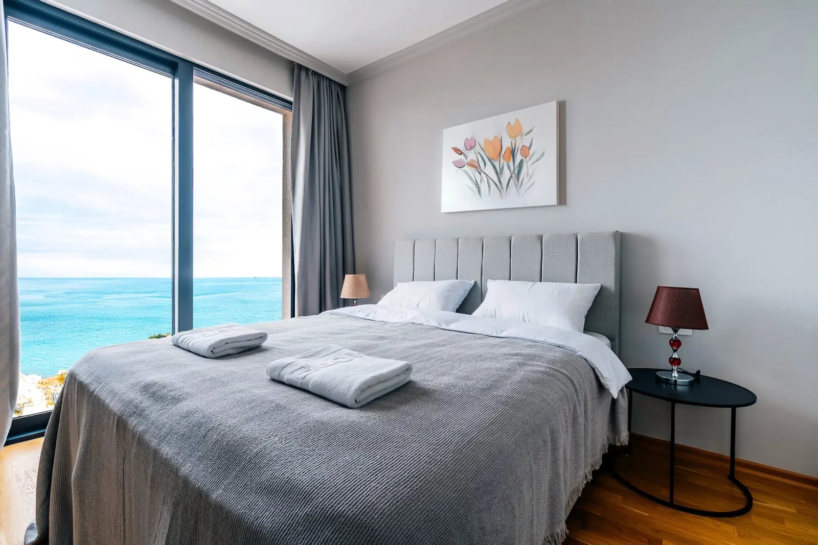 Bedroom with a panoramic sea view in a villa, Reževići, Montenegro: double bed, modern interior and decor.