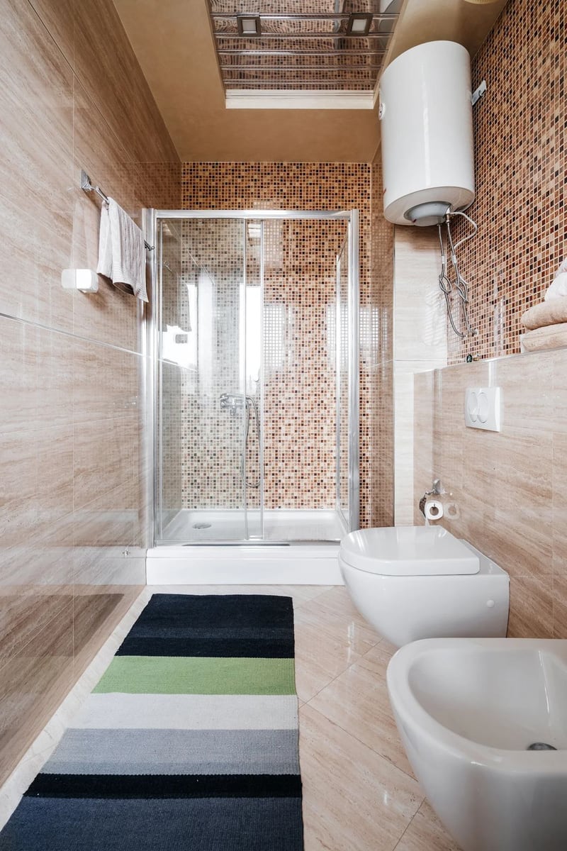 Modern bathroom with a shower cabin and mosaic in an apartment, Budva, Montenegro.