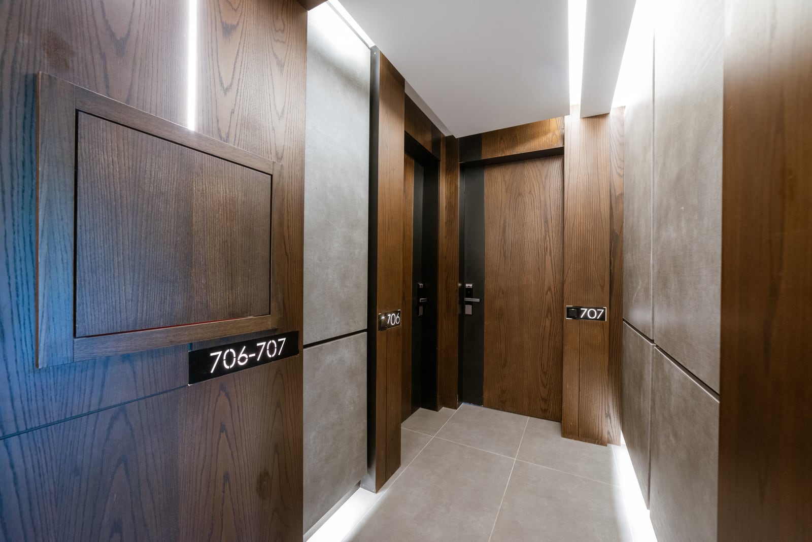 Modern hallway with wood finishing and lighting in a residential complex in Bečići, Montenegro.