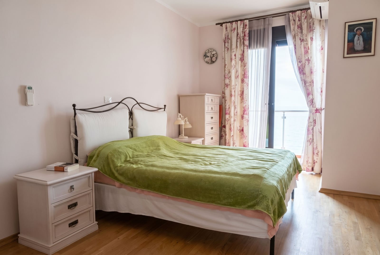 Bright bedroom with a double bed and balcony access featuring a sea view in an apartment, Bar, Montenegro.