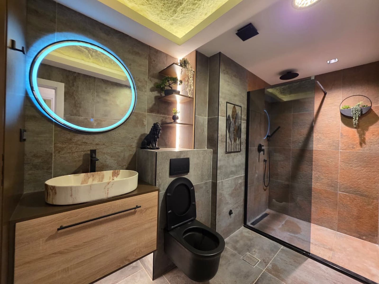 Modern bathroom in an apartment in Bečići, Montenegro: shower cabin, stylish fixtures, and designer lighting.