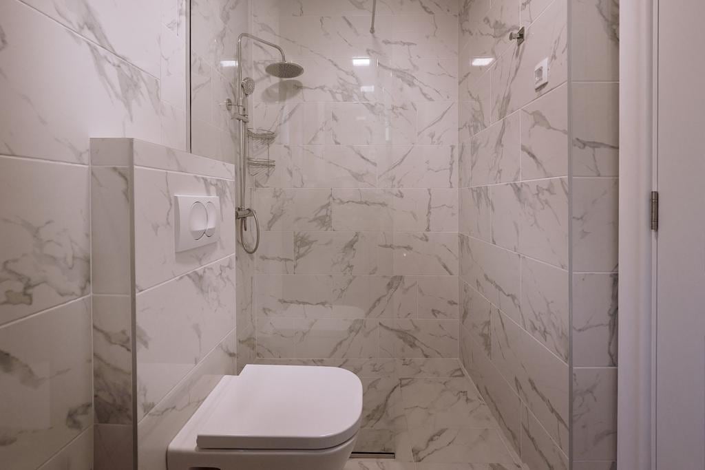 Modern bathroom with a walk-in shower and marble-style finishes in an apartment in Pržno, Montenegro.