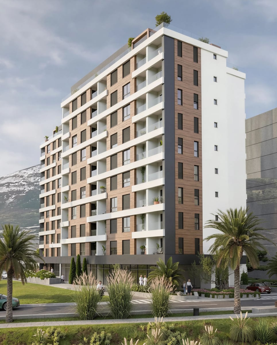 Modern residential complex with terraces in Bar, Montenegro: view of the building facade with palm trees and mountains.