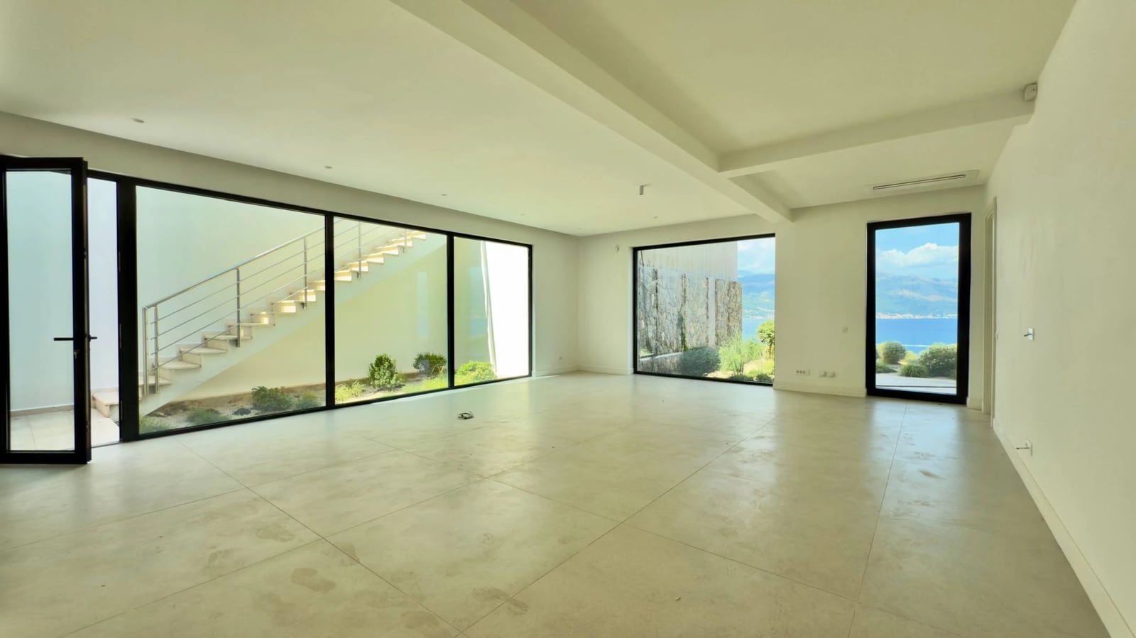 Spacious living room with panoramic windows and sea views in a modern villa, Krašići, Montenegro.