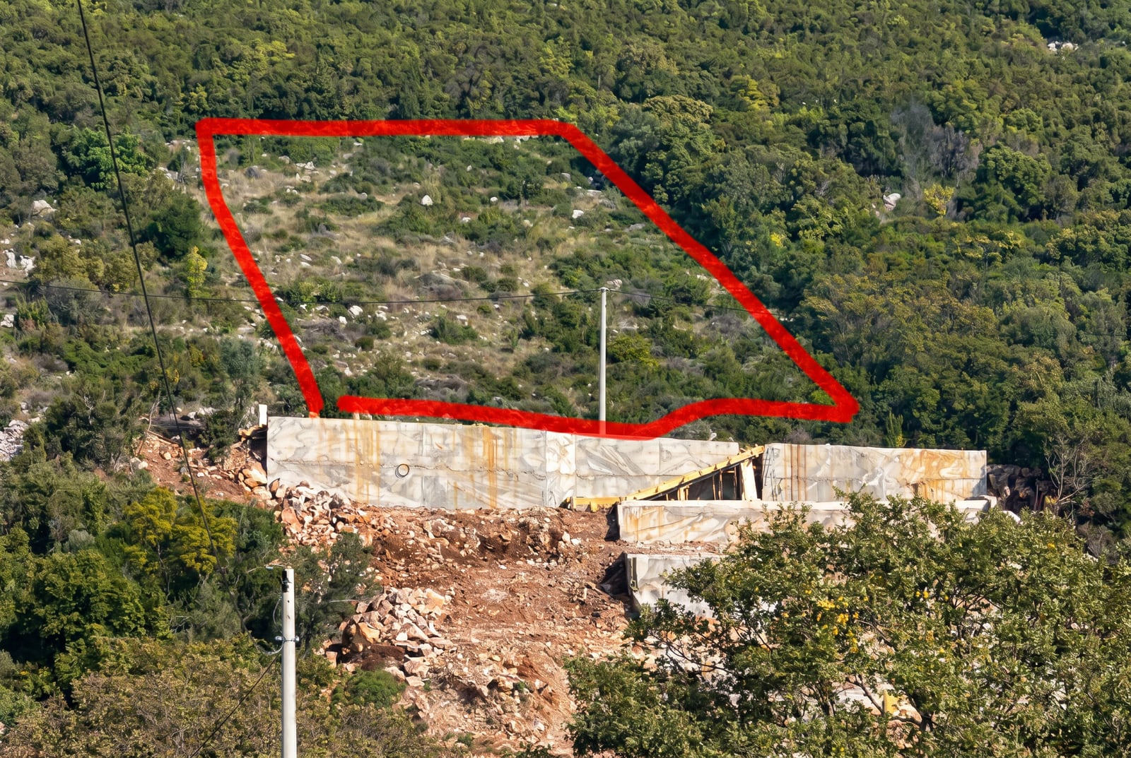 Building plot with a concrete foundation surrounded by forest, Budva, Montenegro.