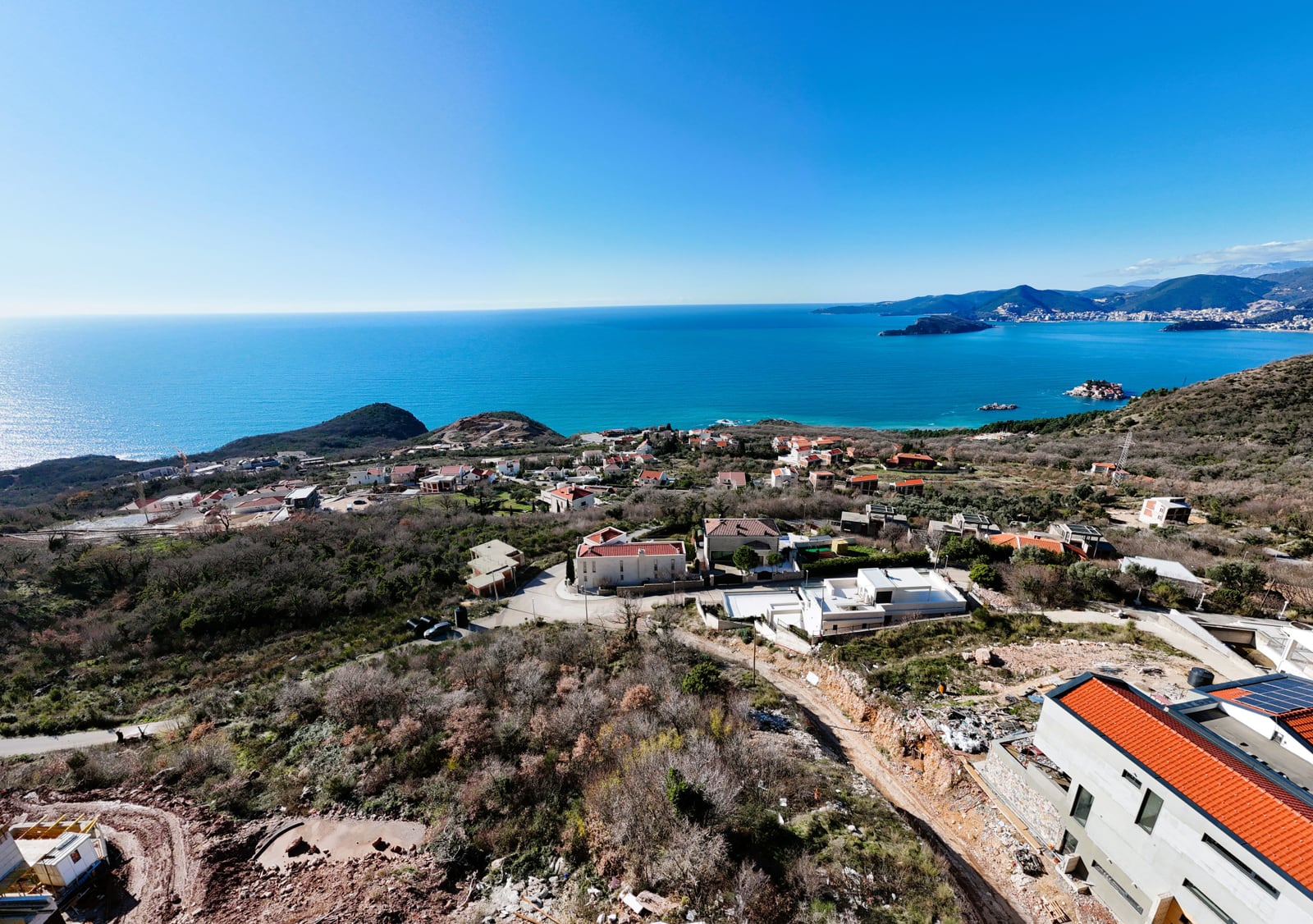 Panoramic sea view of the island of Sveti Stefan from a land plot in Blizikuće, Montenegro.