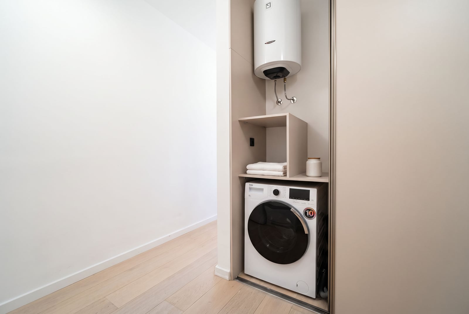 Built-in washing machine and water heater in the bathroom niche of an apartment in Tivat, Montenegro.