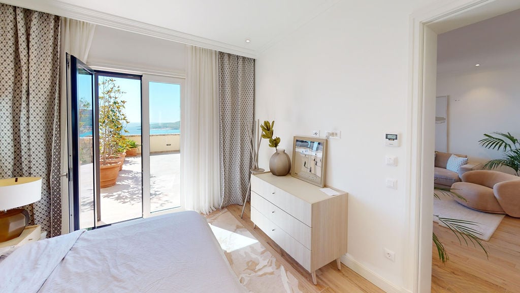 Bright bedroom with terrace access and sea view in Luštica Bay, Montenegro: modern furniture and cozy interior.