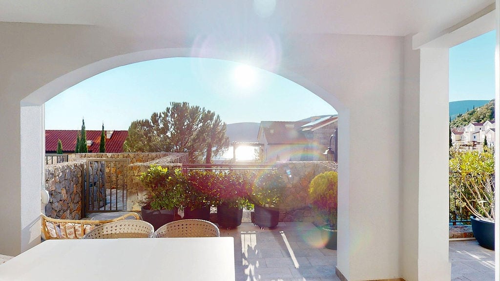 Cozy terrace with wicker chairs and sea view in a residential complex, Luštica, Montenegro.