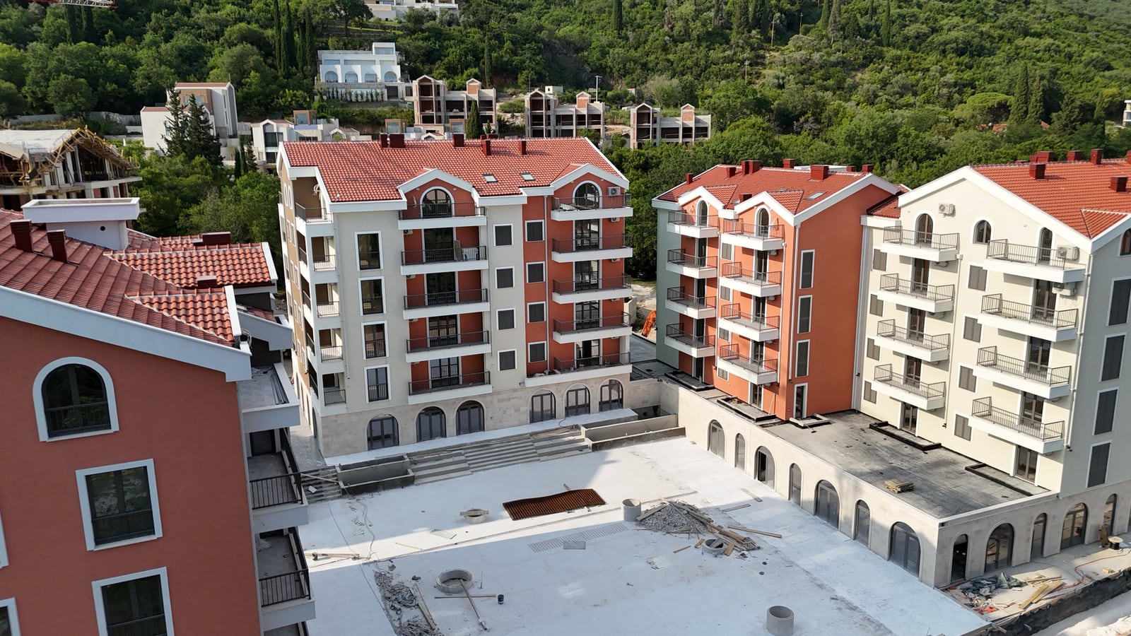 Aerial view of modern residential buildings with red roofs and balconies in the town of Tivat, Montenegro.