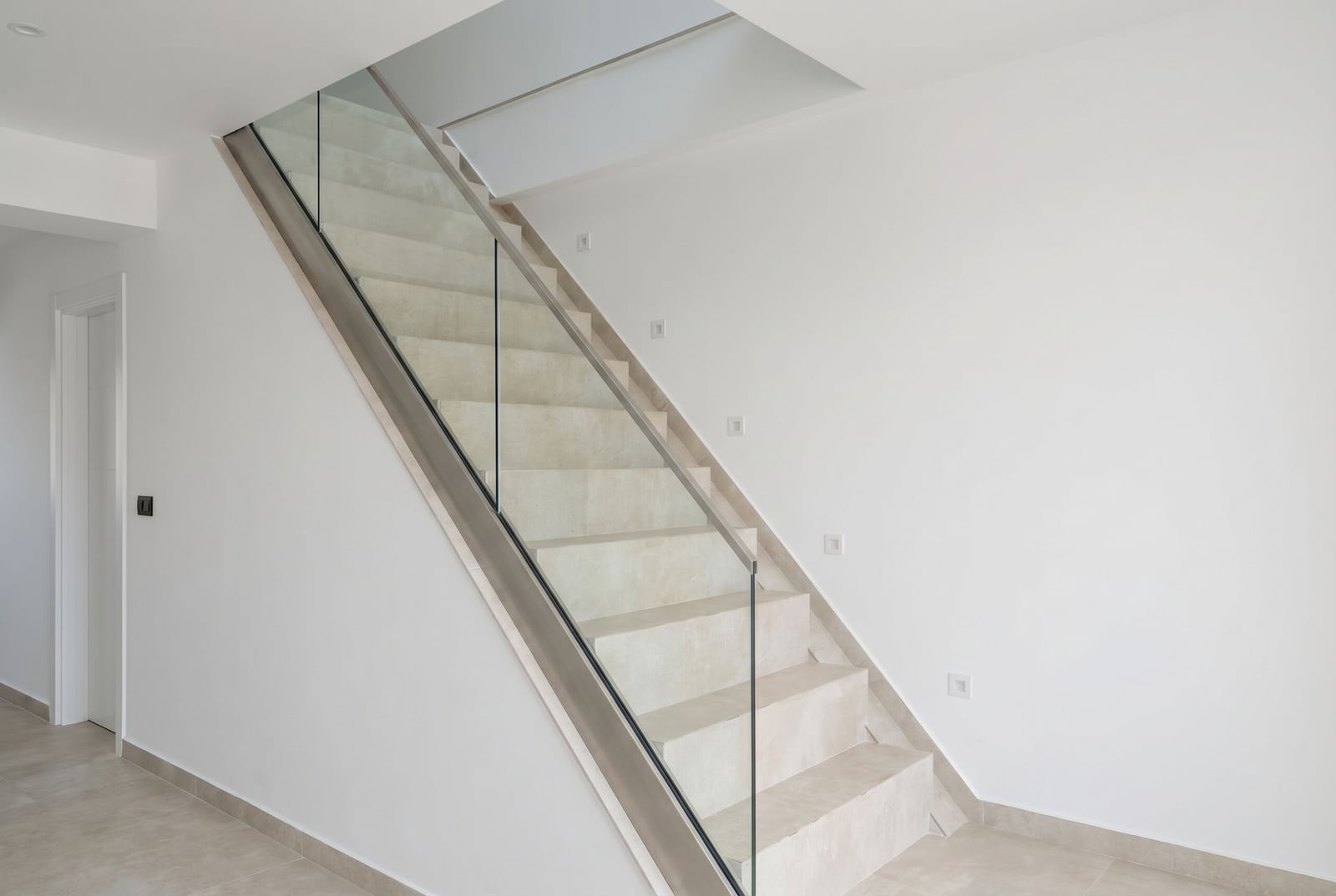 Modern staircase with stone steps and glass railing in an office space, Budva, Montenegro.