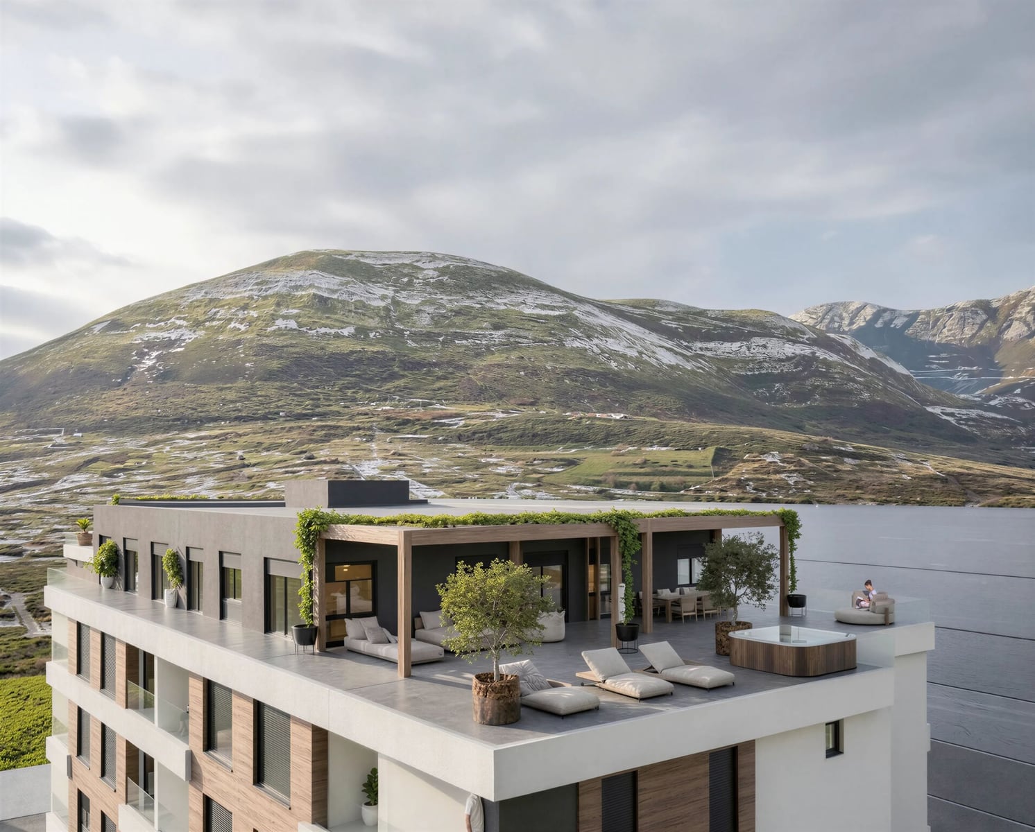 Penthouse terrace with a jacuzzi and sun loungers in a residential complex in Bar, Montenegro, with panoramic mountain and sea views.