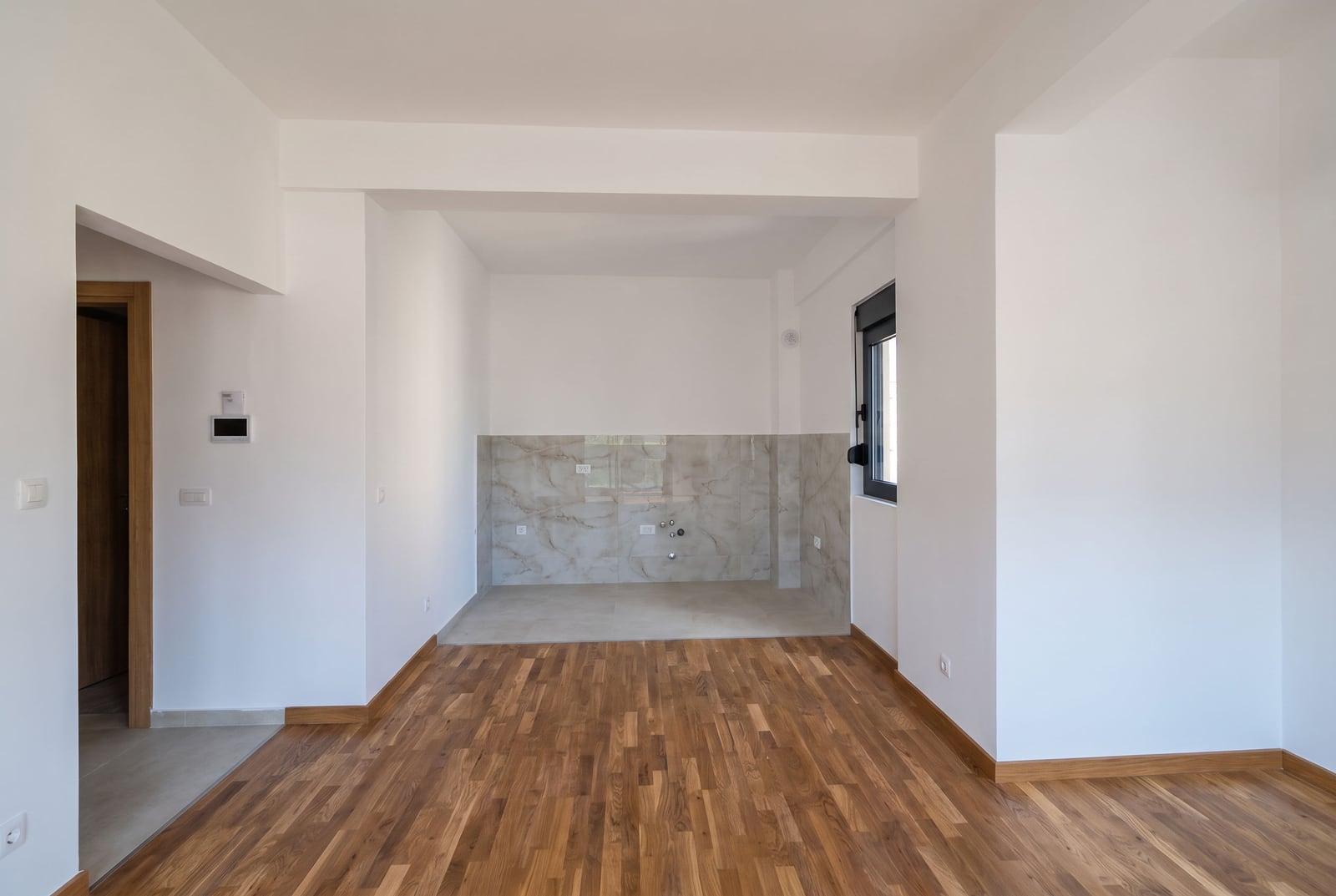 New apartment in Bar, Montenegro: spacious kitchen-living room with finished finishes, parquet flooring, and utility hookups
