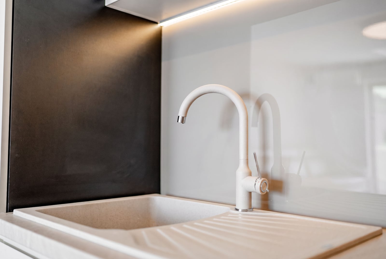 Modern kitchen with a beige sink and faucet in an apartment, Sveti Stefan, Montenegro: stylish interior and finishes.