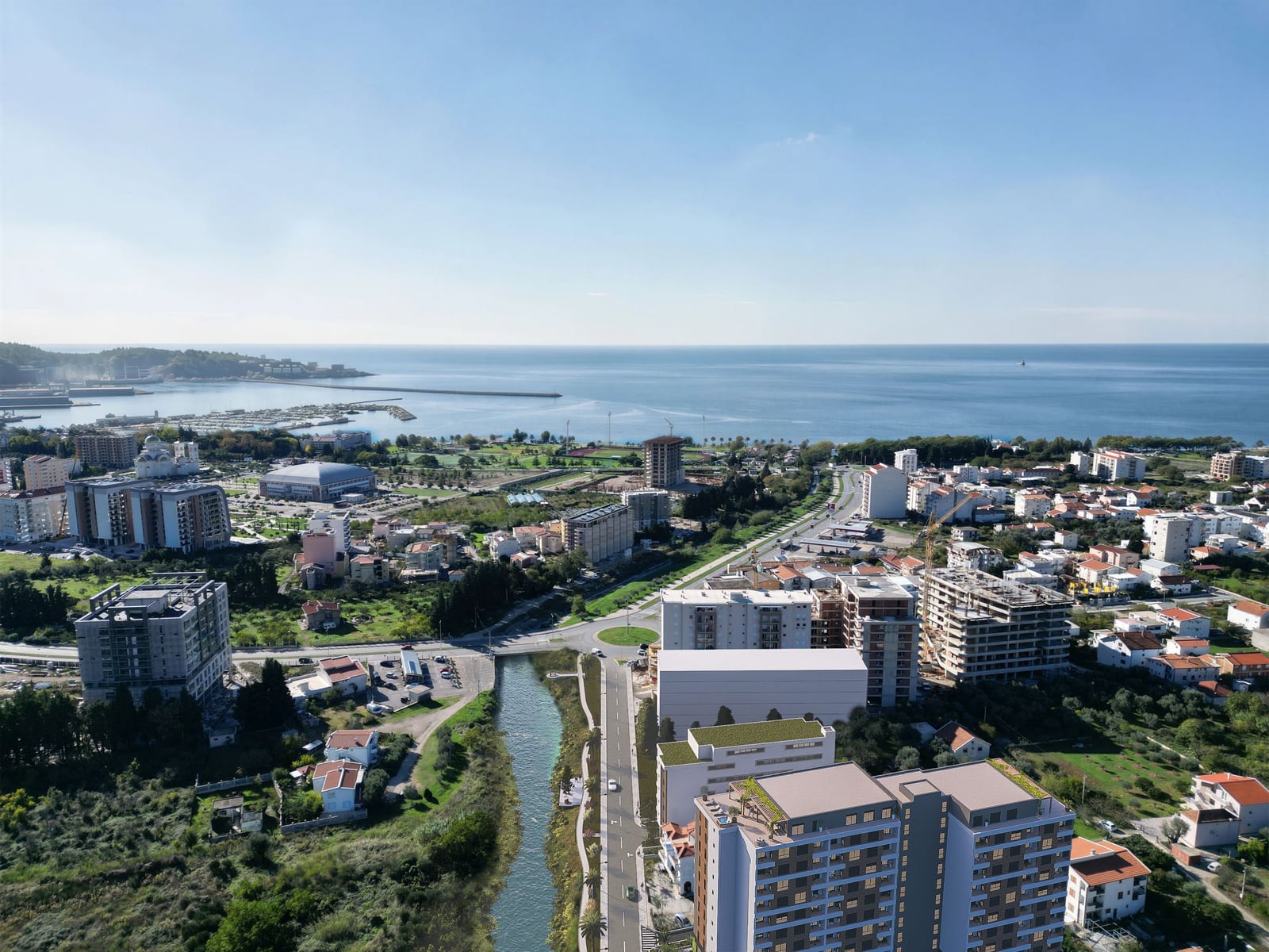 Panoramic view of a residential complex in Bar, Montenegro, overlooking the city infrastructure and the sea coast.