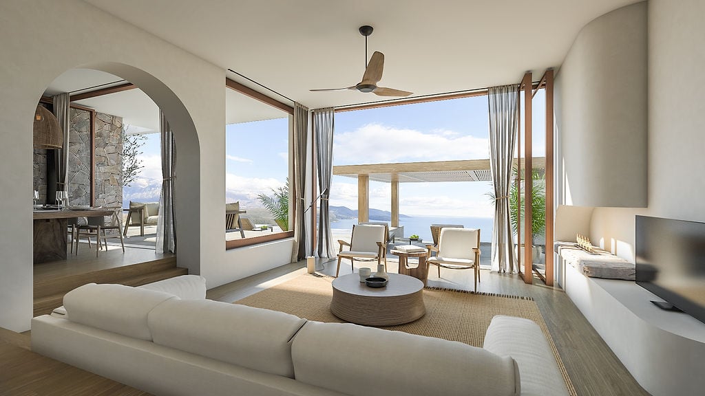 Modern living room in a villa in Luštica, Montenegro: panoramic windows with sea views, light-colored furniture, and a terrace.