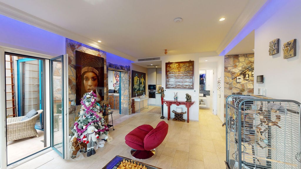 Living room in a townhouse in Luštica, Montenegro: modern interior with stone finishes, neon lighting, and a terrace.