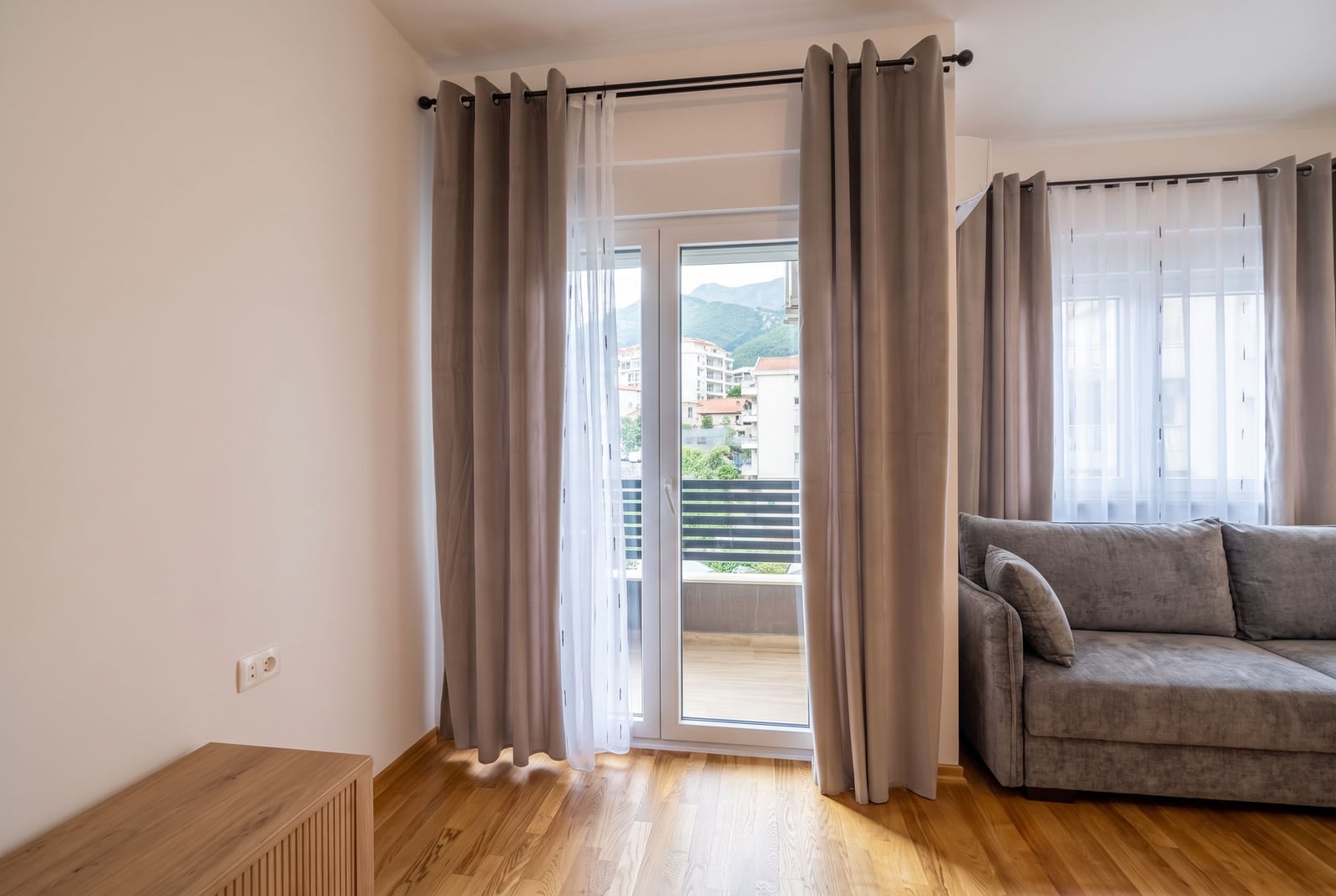 Living room with balcony access and mountain views in an apartment in Budva, Montenegro