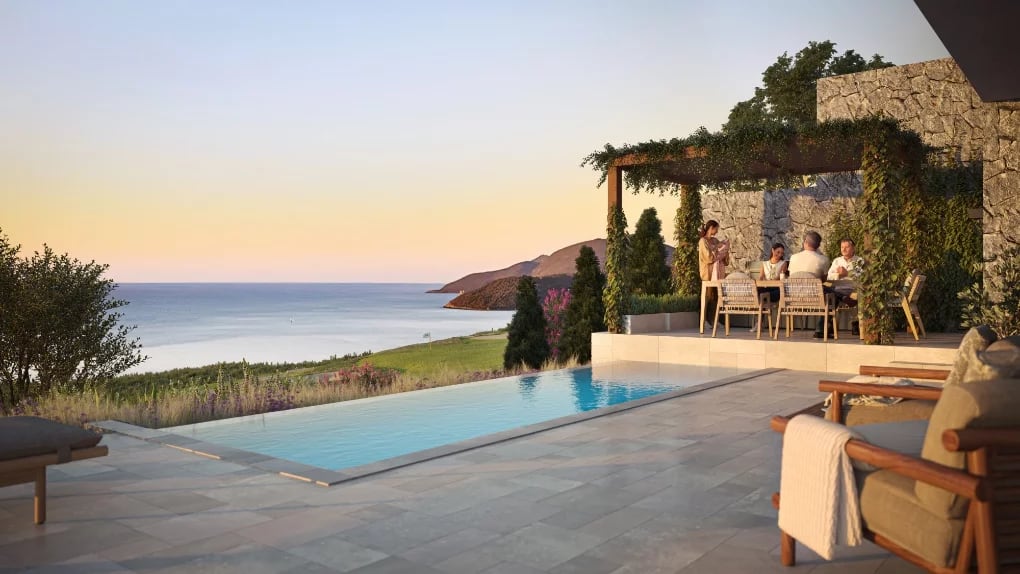 Luxury villa in Luštica, Montenegro: terrace with infinity pool, dining area under a pergola, and sea view.