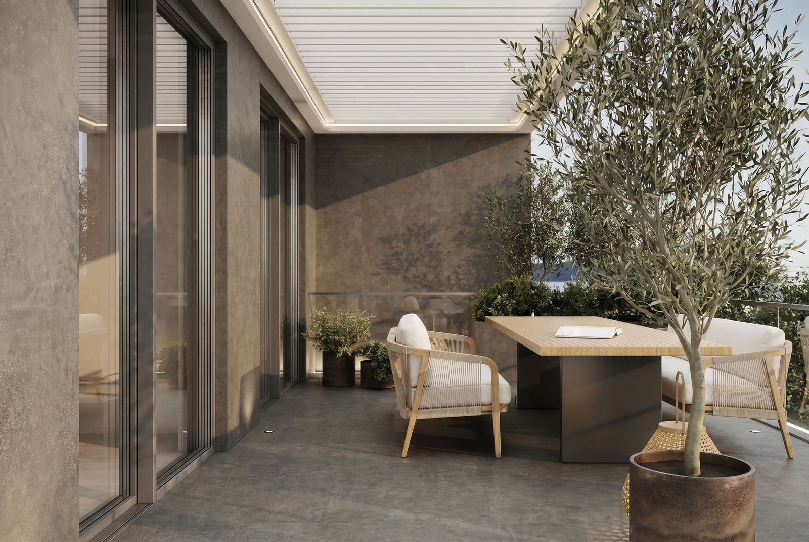 Cozy terrace with a dining area and an olive tree in a luxury residential complex, Sveti Stefan, Montenegro.