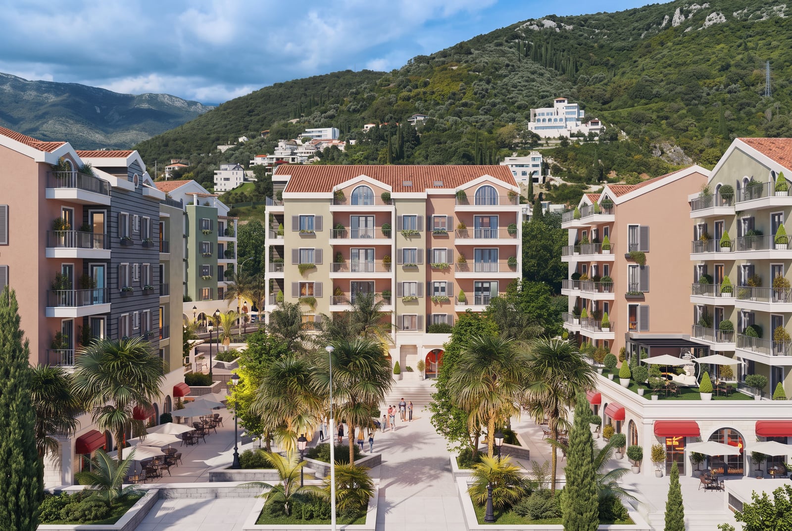 View of a residential complex with multi-story buildings, balconies, and palm trees against green hills.