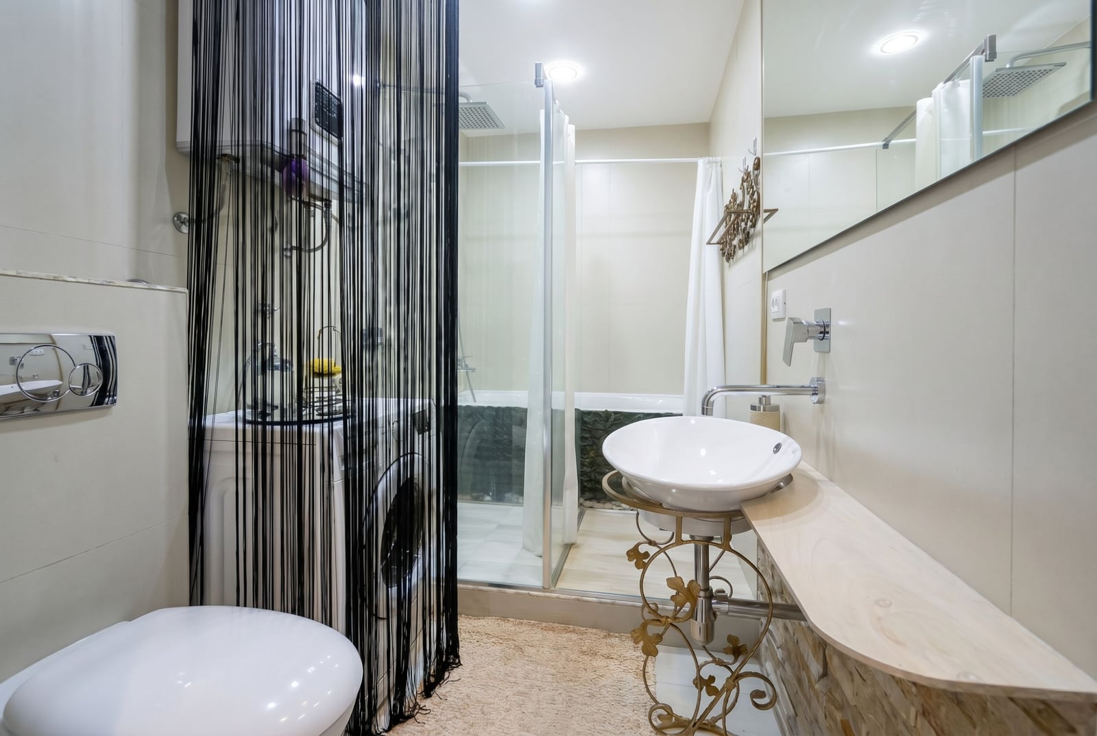 Modern bathroom with a shower cabin and washing machine in an apartment, Becici, Montenegro.