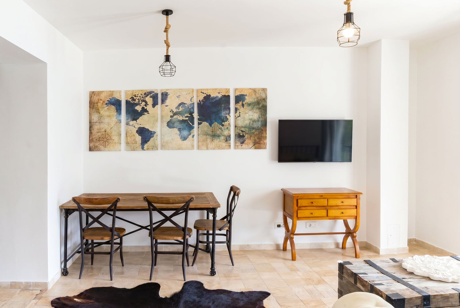 Living room in an apartment in Risan, Montenegro: dining area with a wooden table, vintage furniture, and loft-style decor.