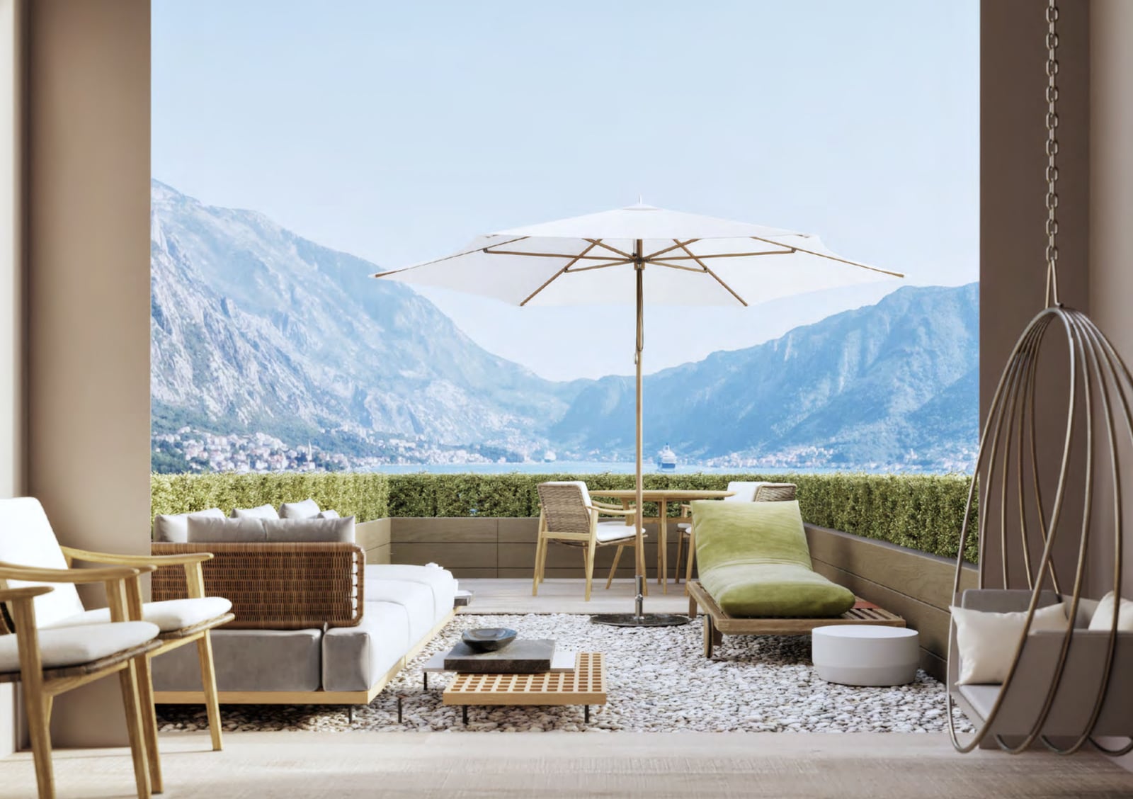 Spacious balcony with wicker furniture, umbrella, and panoramic view of the sea and mountains in Orahovac, Montenegro