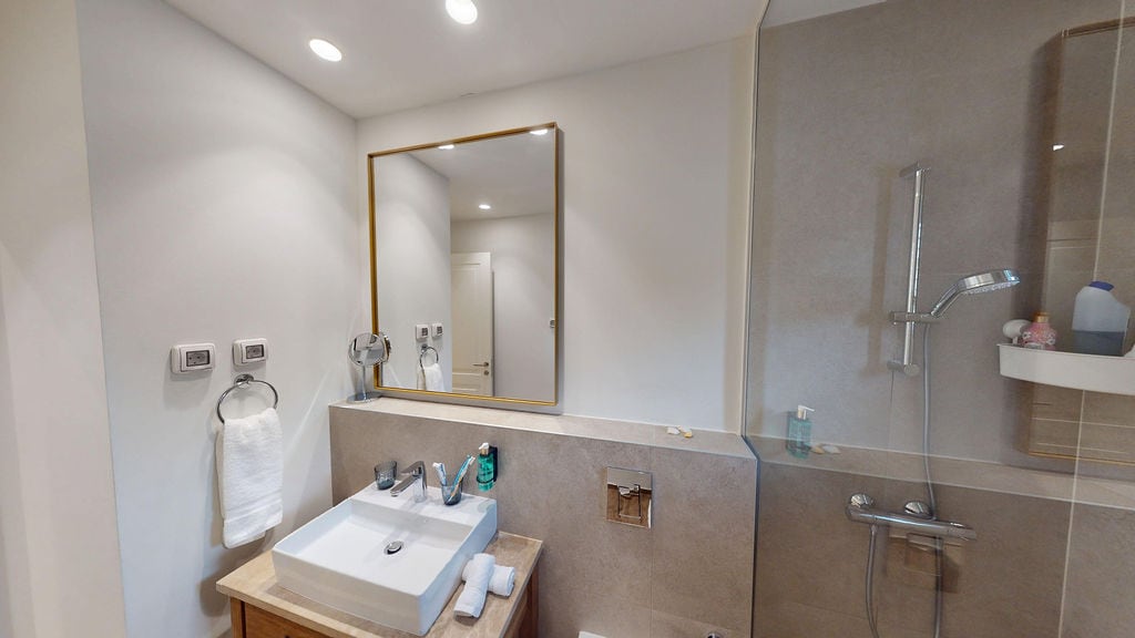 Modern bathroom with a shower cabin and mirror in an apartment, Luštica, Montenegro.