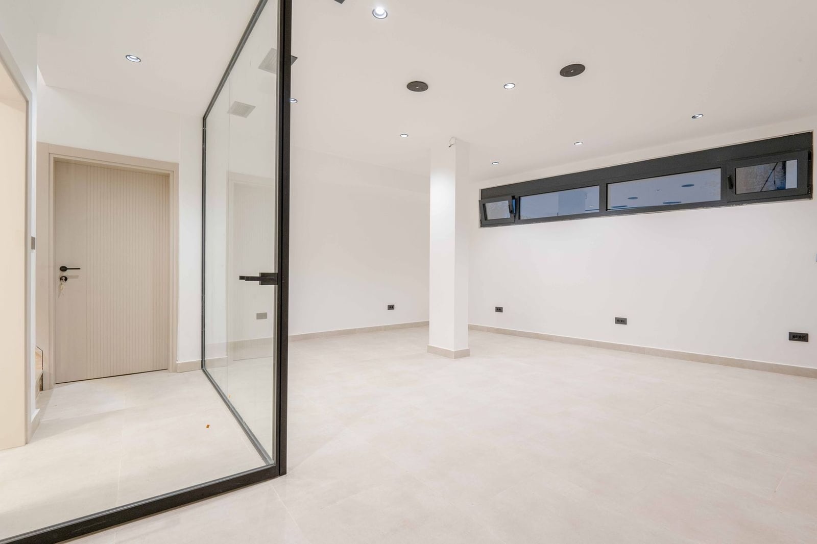Bright empty room with a panoramic glass partition in a modern villa, Kamenovo, Montenegro.
