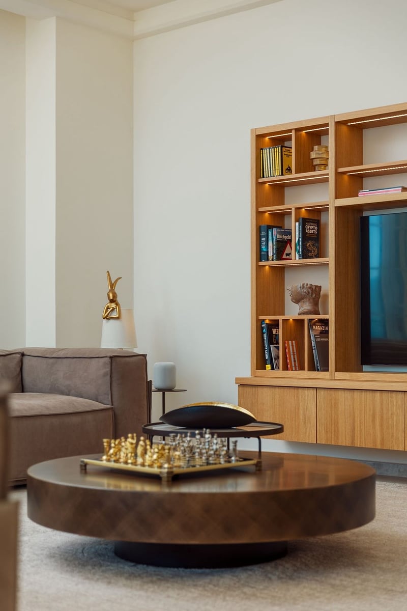 Modern living room with a wooden bookshelf and chess set in the interior of a luxury villa in Luštica, Montenegro.