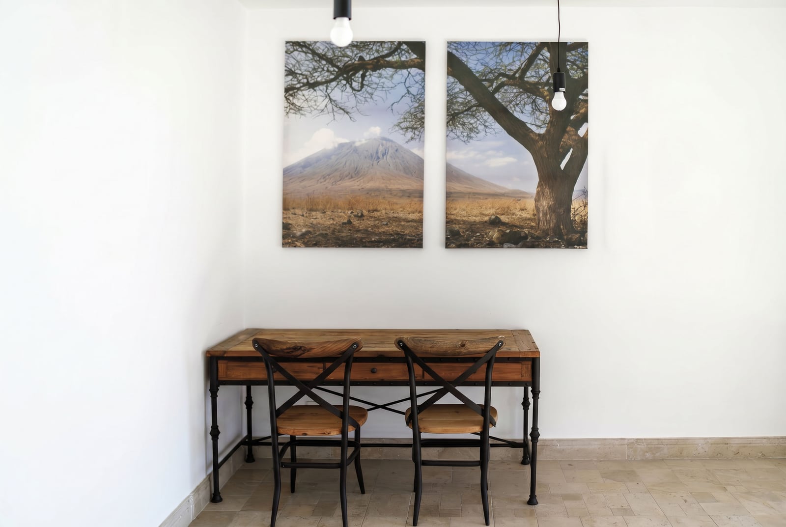 Work area with a wooden table and chairs in the living room of an apartment in Risan, Montenegro, decor with nature paintings.
