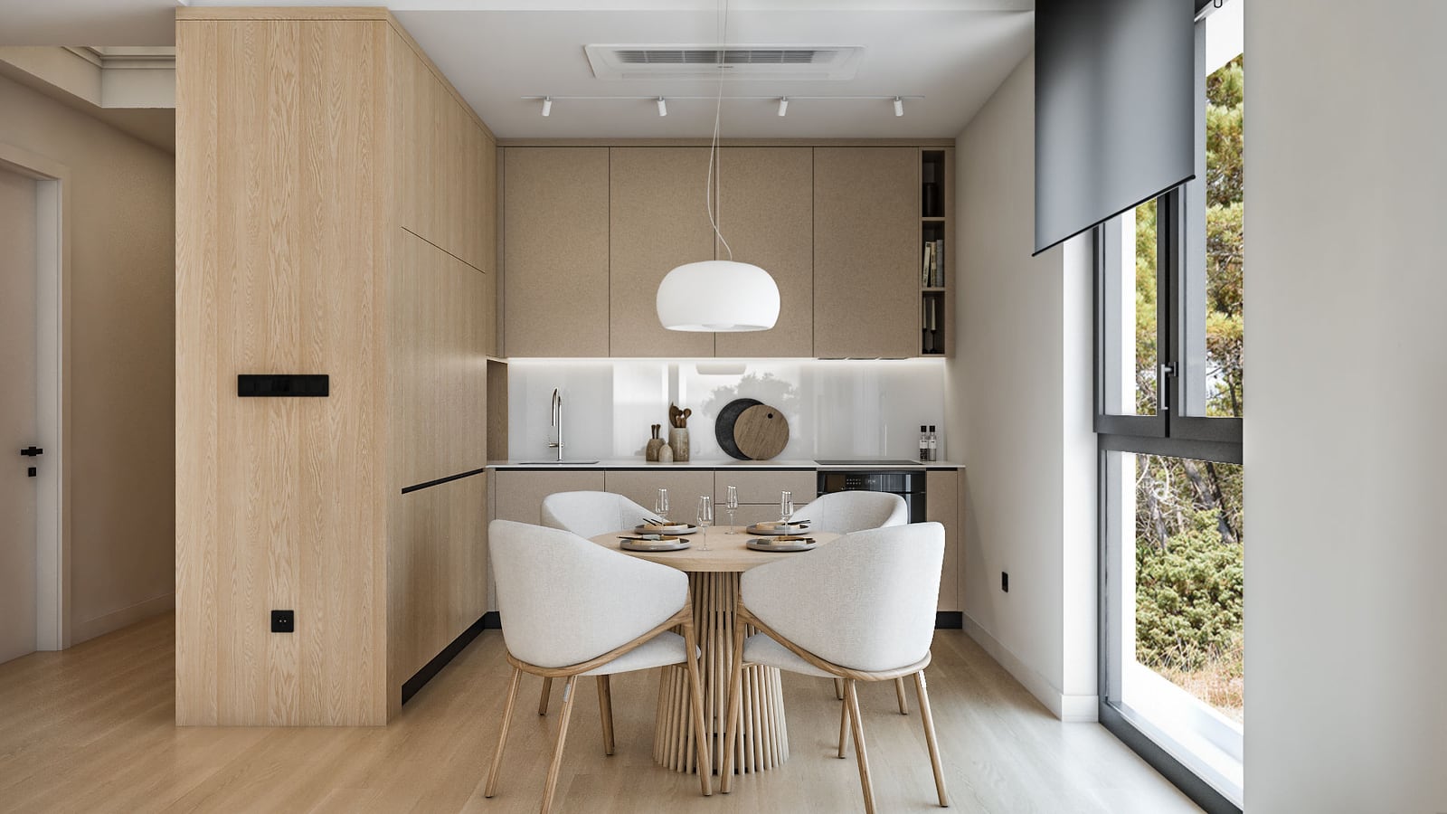 Modern kitchen with light wood cabinetry, a round dining table with white chairs, and a large window overlooking greenery.