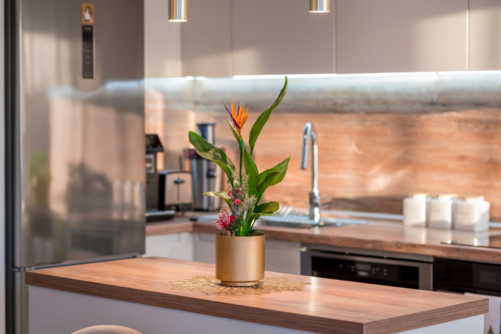 Modern kitchen in an apartment in Tivat, Montenegro: wooden countertop, stylish decor, and built-in appliances.