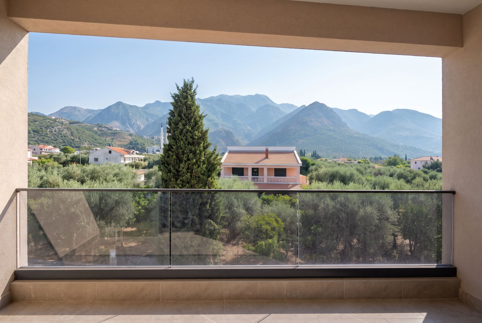 View from the apartment balcony in Bar, Montenegro: panorama of the mountains, garden, and houses