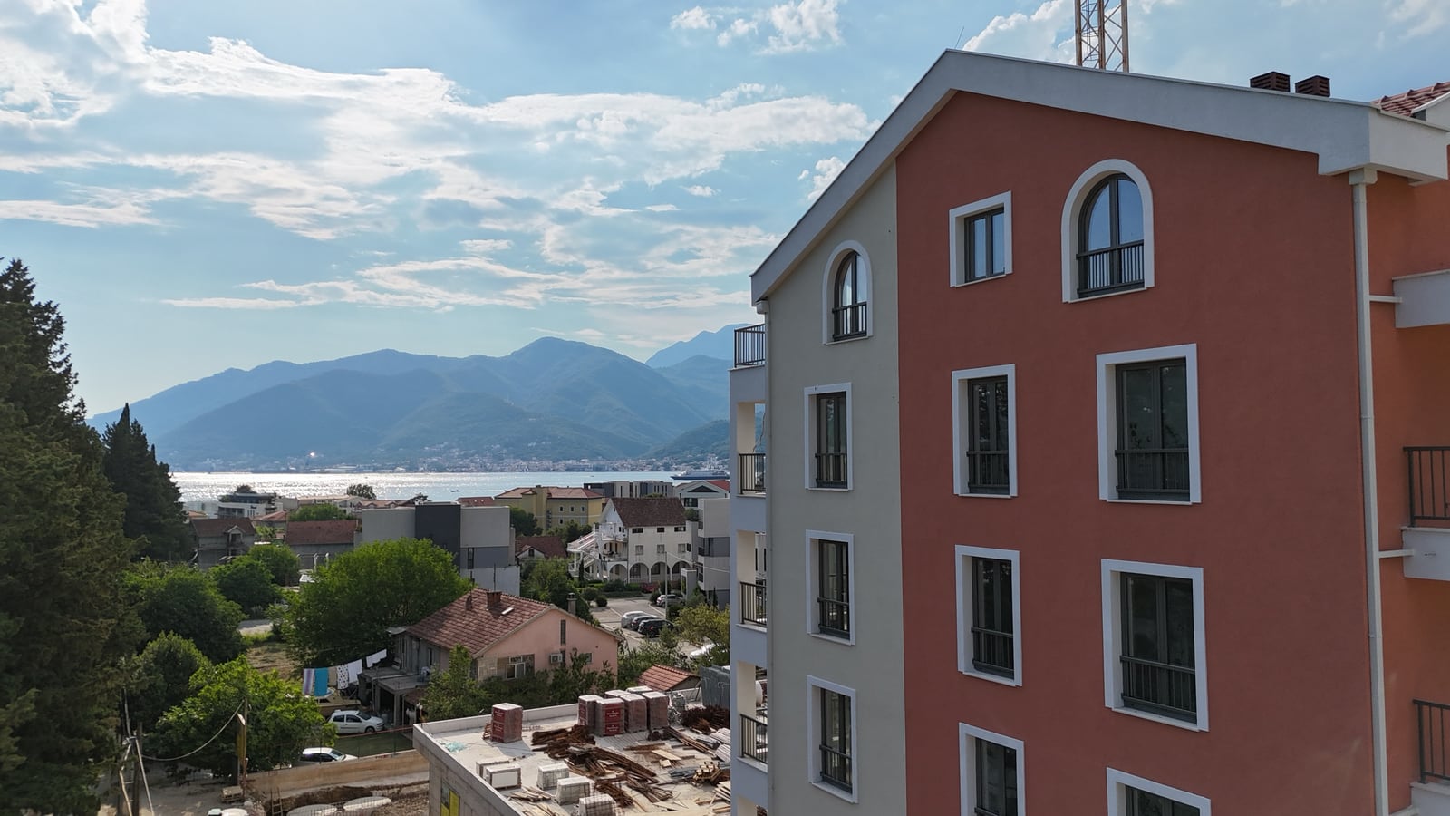 Modern residential building in Tivat, Montenegro, with panoramic sea and mountain views from the apartment windows.